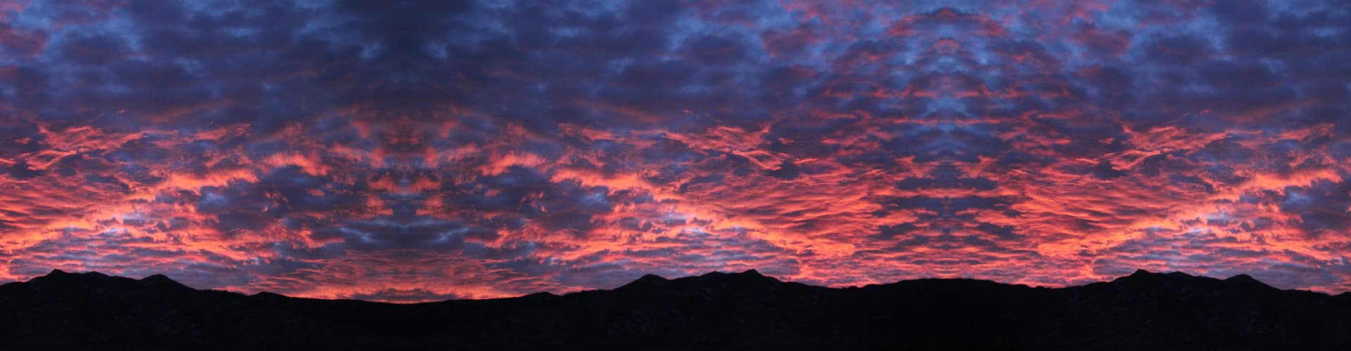 dramatic hot pink dawn over Catalina mountains in tucson, arizona